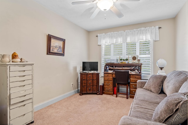 carpeted office space featuring ceiling fan