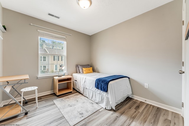 bedroom with hardwood / wood-style floors