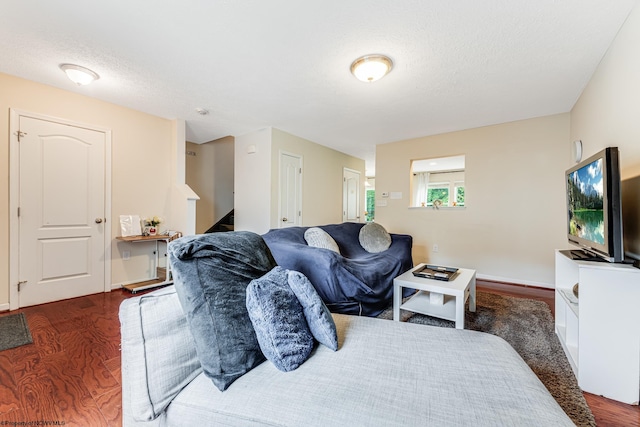 bedroom featuring a textured ceiling and dark hardwood / wood-style floors