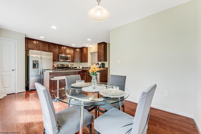 dining area with dark hardwood / wood-style floors