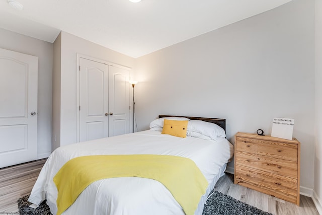 bedroom featuring light hardwood / wood-style floors and a closet