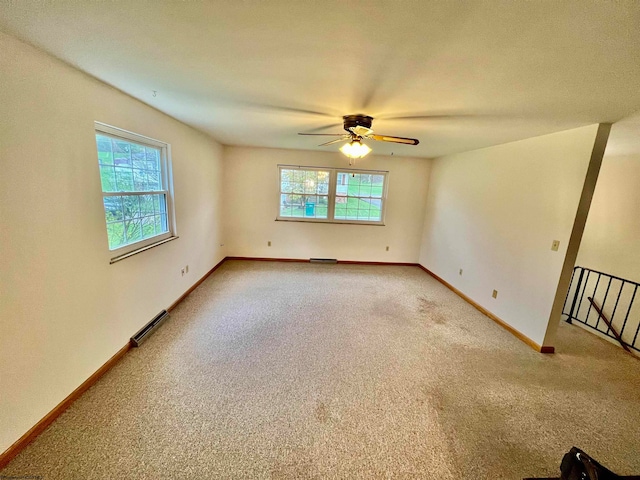 carpeted spare room with a healthy amount of sunlight and ceiling fan