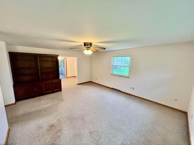 unfurnished bedroom with ceiling fan and light colored carpet