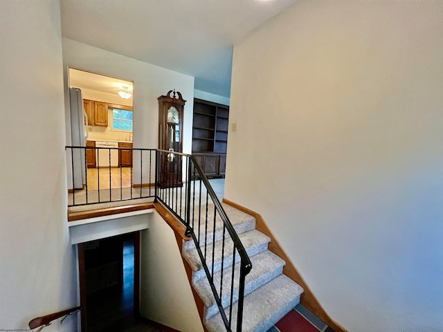 stairway featuring built in shelves