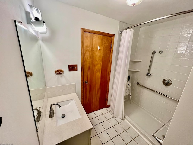 bathroom with a shower with curtain, vanity, and tile patterned flooring