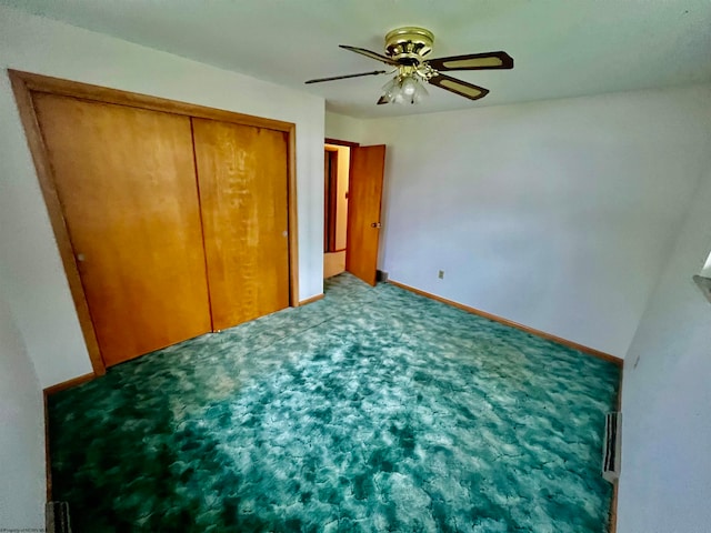 unfurnished bedroom with ceiling fan, a closet, and carpet