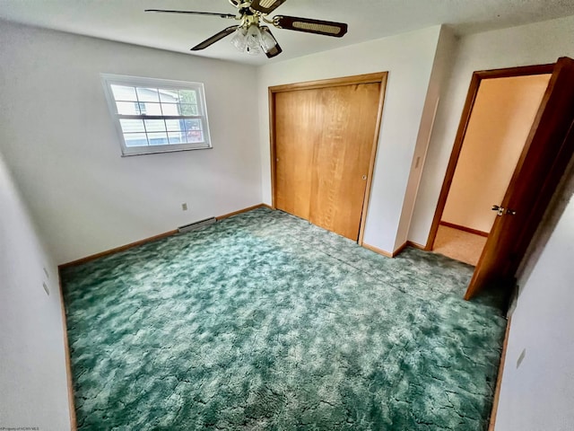 unfurnished bedroom featuring carpet, ceiling fan, and a closet