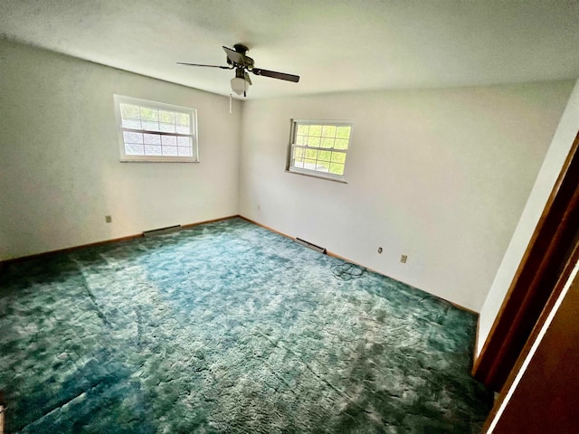 spare room featuring a wealth of natural light, carpet, and ceiling fan