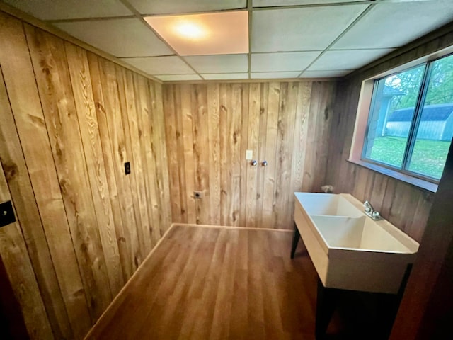 interior space with wood-type flooring and wood walls