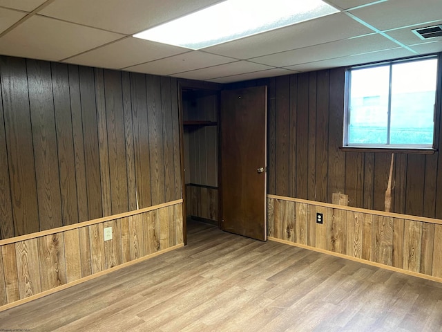 basement featuring wood walls and hardwood / wood-style floors