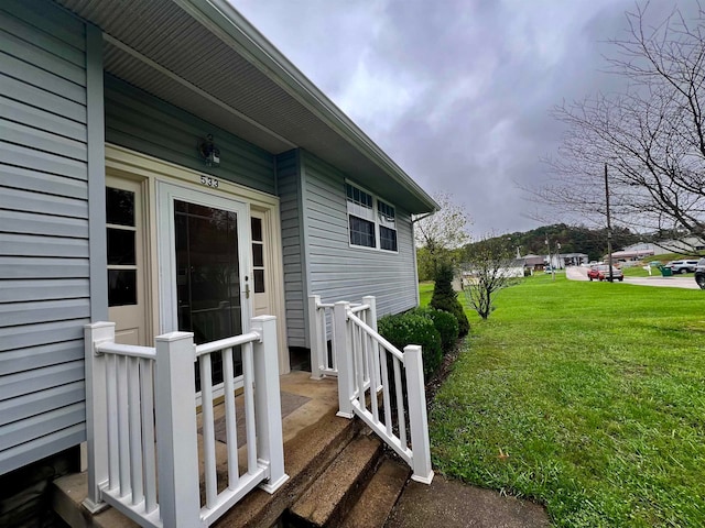 doorway to property with a yard