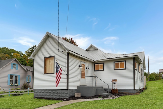 rear view of property with a yard