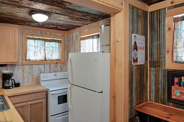 kitchen featuring light brown cabinets and white appliances