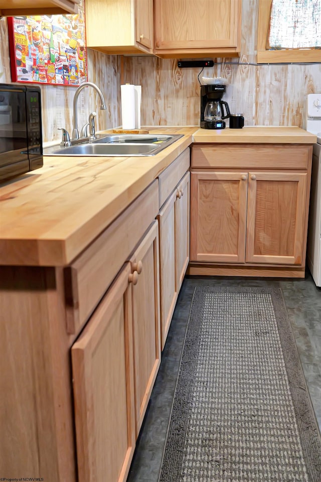 kitchen with light brown cabinetry, butcher block countertops, and sink