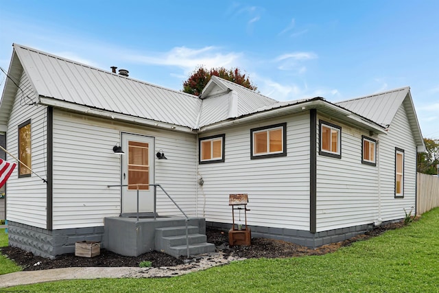 rear view of house with a yard