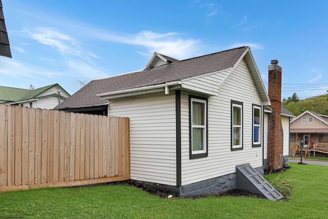 view of side of property with a yard