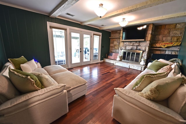 living room featuring wood walls, beam ceiling, french doors, dark hardwood / wood-style floors, and a fireplace