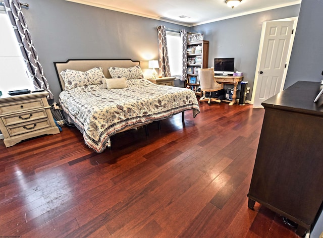 bedroom with ornamental molding and dark hardwood / wood-style flooring