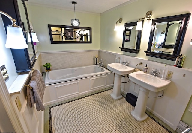 bathroom featuring tile patterned flooring, ornamental molding, and a tub