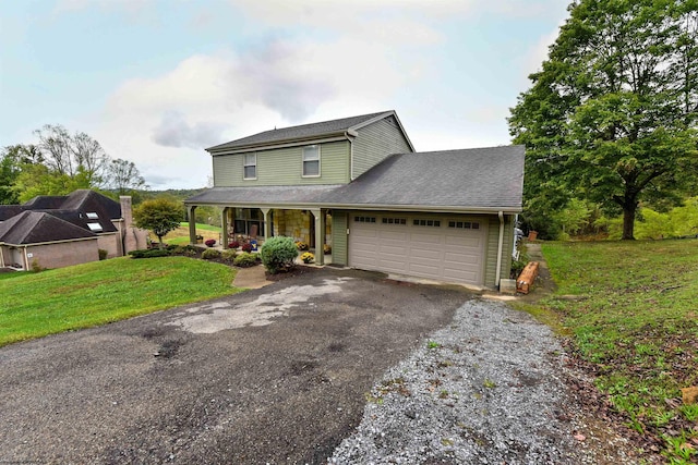 view of front of home featuring a garage, a porch, and a front lawn