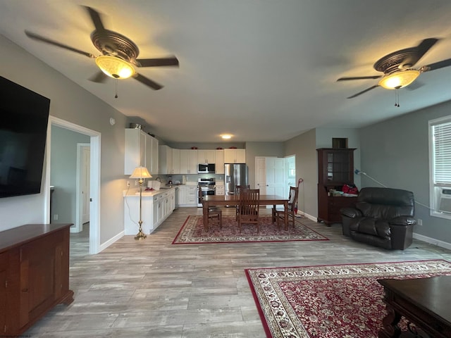 living room with light wood-type flooring and ceiling fan