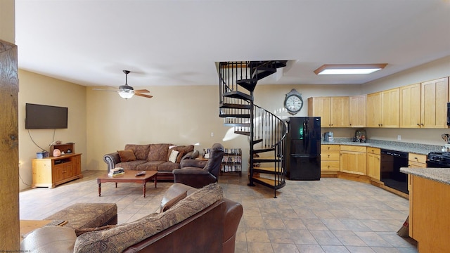 kitchen featuring light brown cabinetry, ceiling fan, and black appliances