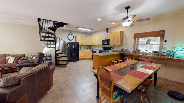 dining room featuring ceiling fan and tile patterned floors