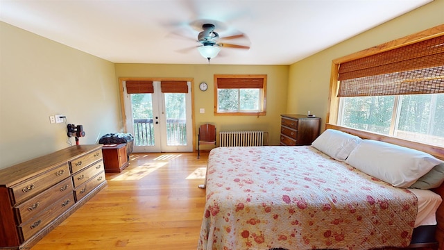 bedroom with ceiling fan, radiator heating unit, french doors, light hardwood / wood-style flooring, and access to exterior