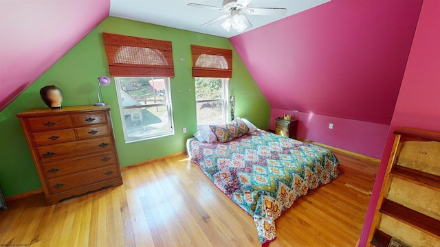 bedroom featuring ceiling fan, lofted ceiling, and light hardwood / wood-style floors