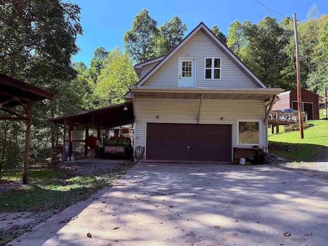 view of side of property featuring a carport, a yard, and a garage