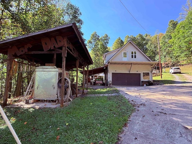 view of side of property featuring a lawn and a garage