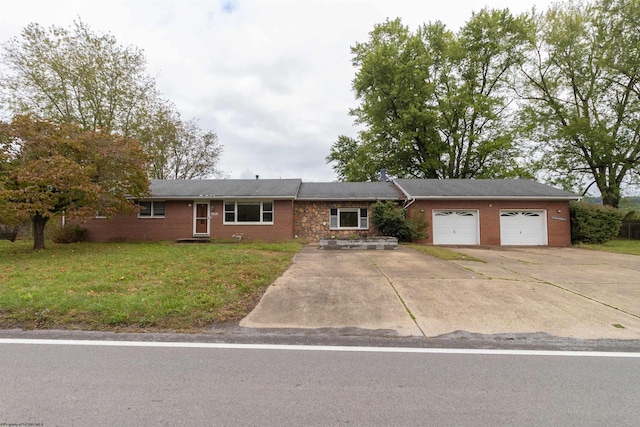 ranch-style house featuring a front lawn and a garage