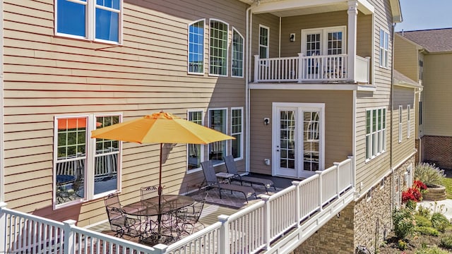 back of house featuring a balcony