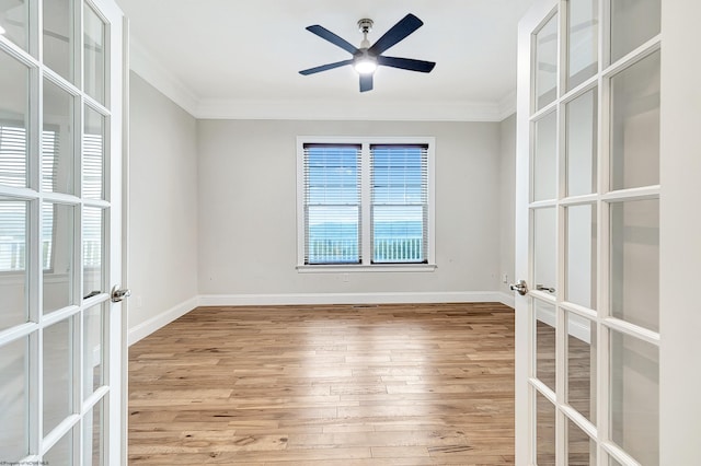 unfurnished room featuring french doors, crown molding, and wood-type flooring