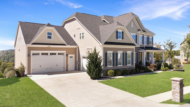 craftsman house with a front yard and a garage