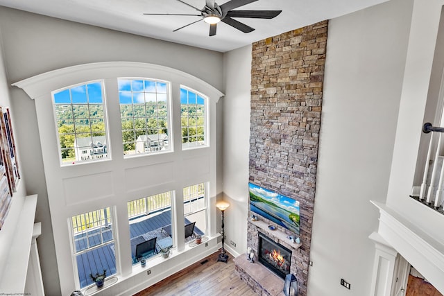 living room featuring hardwood / wood-style flooring, ceiling fan, and a wealth of natural light