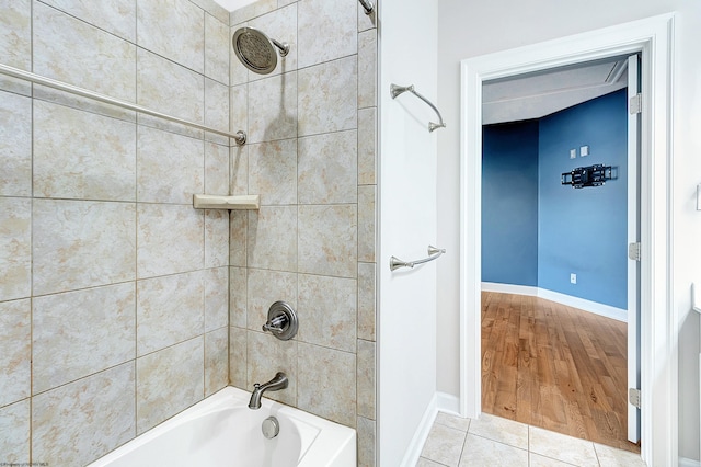 bathroom featuring wood-type flooring and tiled shower / bath combo