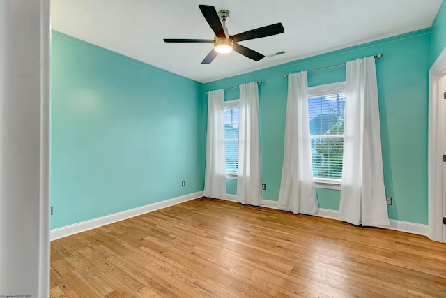 unfurnished room featuring light wood-type flooring, ceiling fan, and crown molding