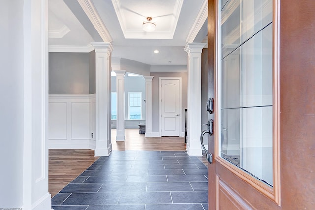 hall featuring ornate columns, a tray ceiling, dark hardwood / wood-style floors, and crown molding