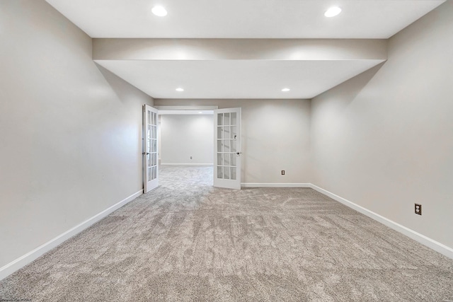 carpeted empty room featuring french doors