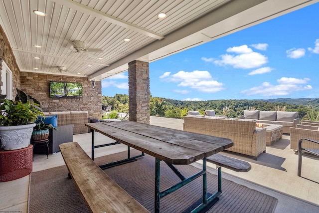 view of patio featuring ceiling fan and an outdoor living space