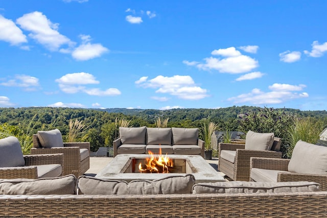 view of patio / terrace with an outdoor living space with a fire pit