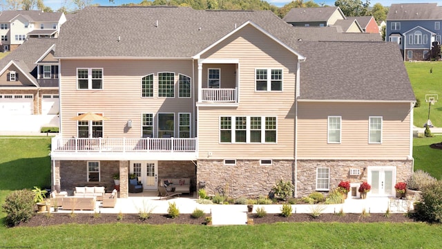 rear view of house featuring a balcony, an outdoor hangout area, a patio area, and a yard