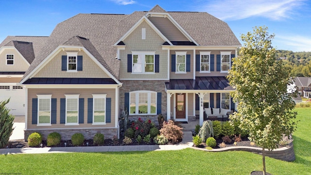 craftsman inspired home with a porch and a front yard