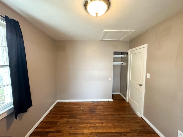 unfurnished bedroom featuring dark hardwood / wood-style floors and a closet