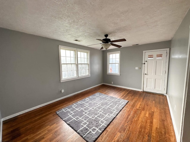 foyer entrance featuring a textured ceiling, wood-type flooring, and ceiling fan