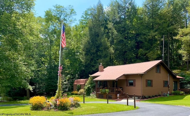 view of front of property with a porch and a front yard