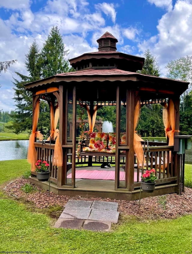 surrounding community featuring a gazebo, a water view, and a yard