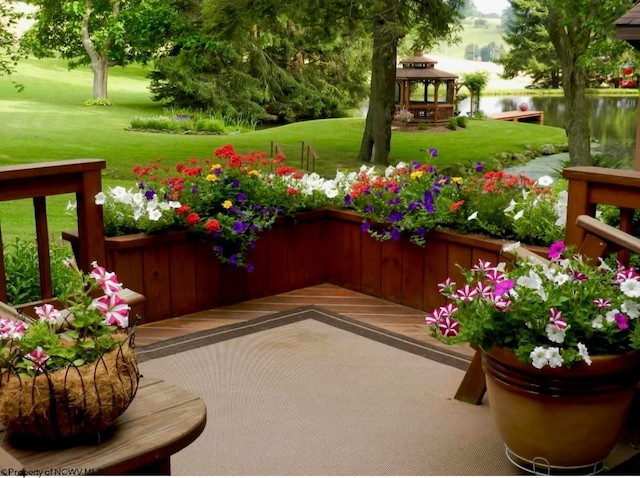 exterior space featuring a lawn, a gazebo, and a water view