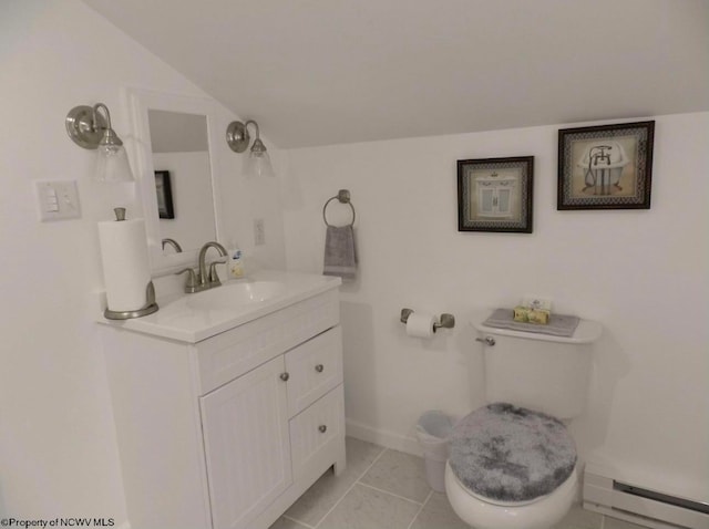 bathroom featuring tile patterned flooring, vanity, toilet, and a baseboard heating unit